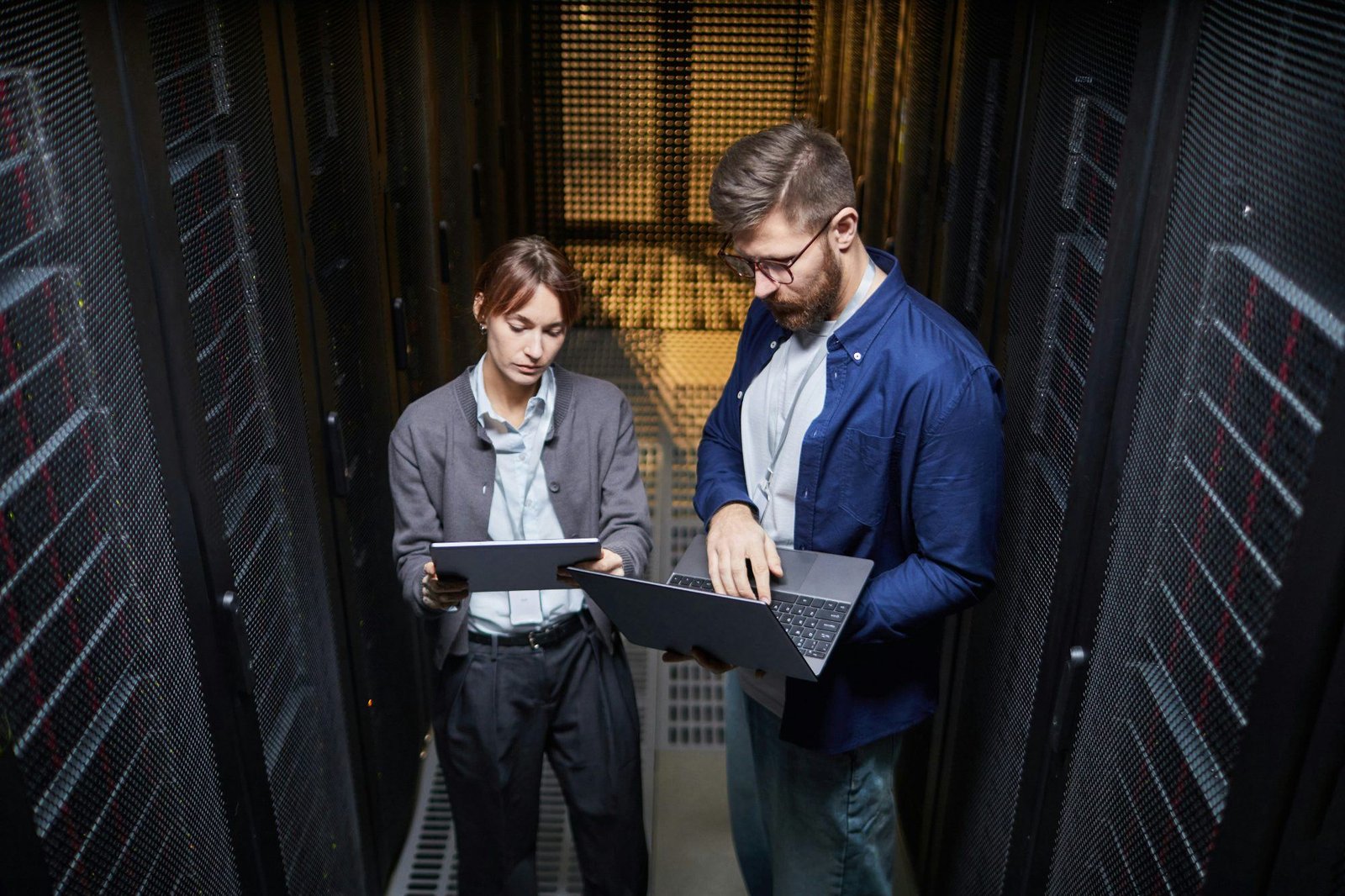 Technicians working in a data center aisle